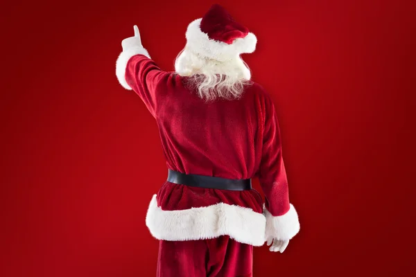 Santa Claus punten op iets — Stockfoto