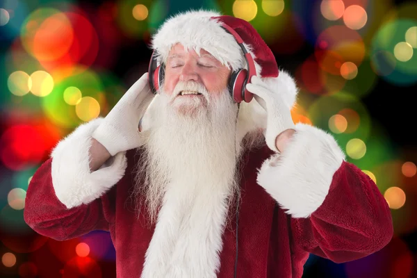 Santa Claus enjoys some music — Stock Photo, Image