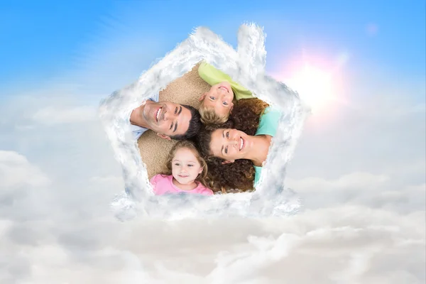 Happy family lying on the rug in a circle — Stock Photo, Image