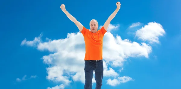 Mature man in orange tshirt cheering — Stock Photo, Image