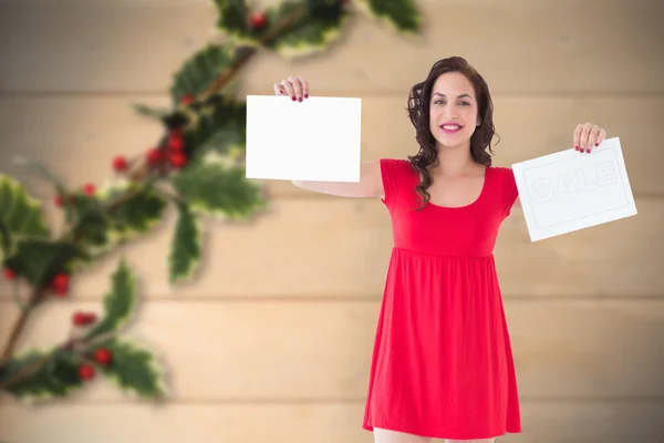 Stylish brunette in red dress holding pages — Stock Photo, Image