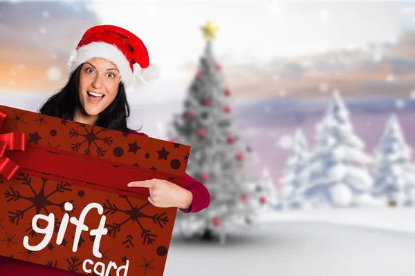 Woman pointing at gift card — Stock Photo, Image