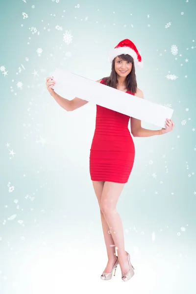 Festive brunette showing a blank banner — Stock Photo, Image