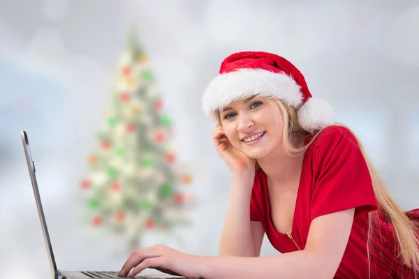 Festive blonde using a laptop — Stock Photo, Image