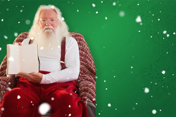 Father christmas showing a book — Stock Photo, Image