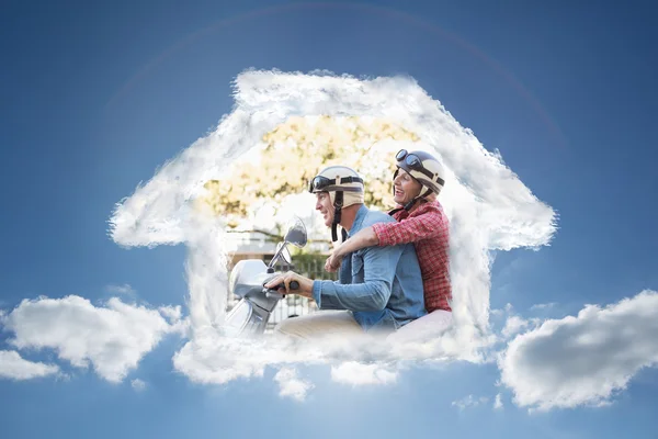 Happy mature couple riding a scooter — Stock Photo, Image