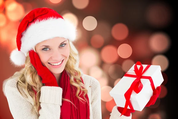 Happy festive blonde with gift Stock Image