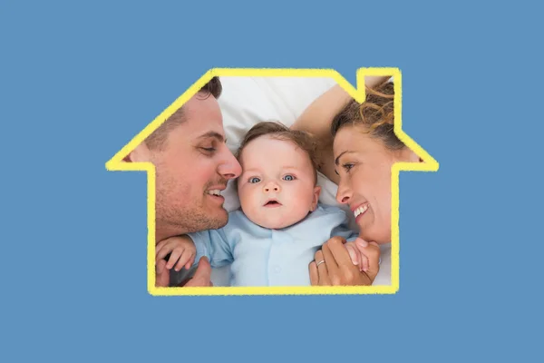 Cute baby with parents in bed — Stock Photo, Image
