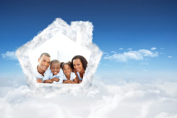 Happy family having fun lying down on bed — Stock Photo, Image