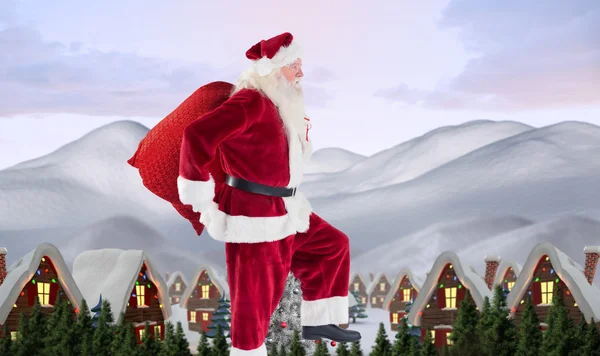 Babbo Natale salta con la sua borsa — Foto Stock