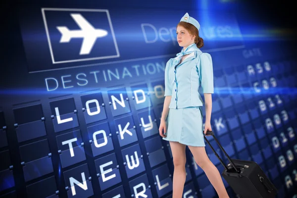 Pretty air hostess pulling suitcase — Stock Photo, Image