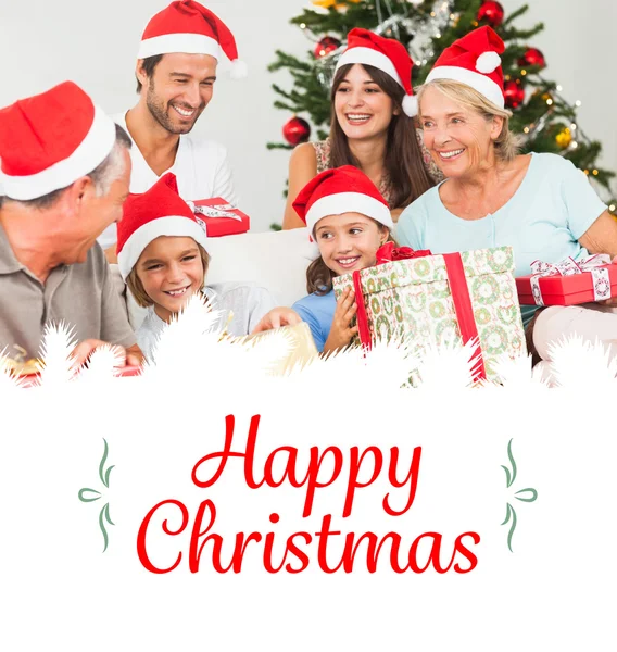 Happy family at christmas swapping gifts — Stock Photo, Image