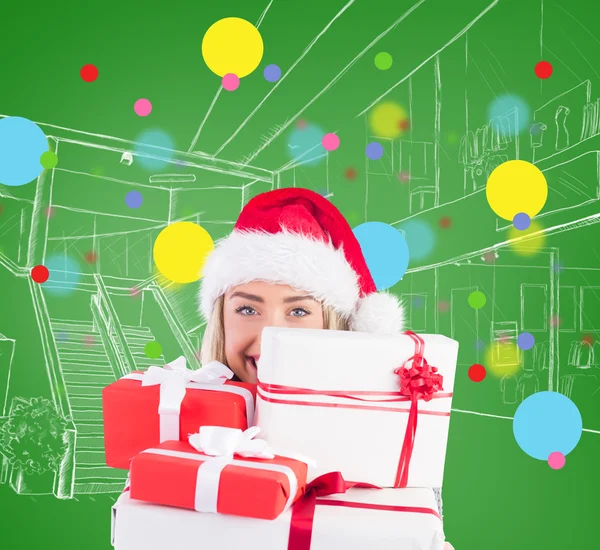 Festive blonde holding pile of gifts — Stock Photo, Image