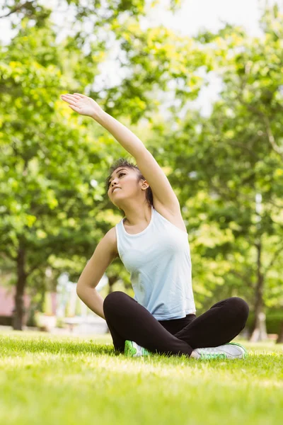 Healthy woman stretching hand in park — Stock Photo, Image