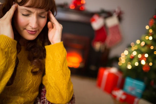 Redhead getting a headache on christmas day — Stock Photo, Image