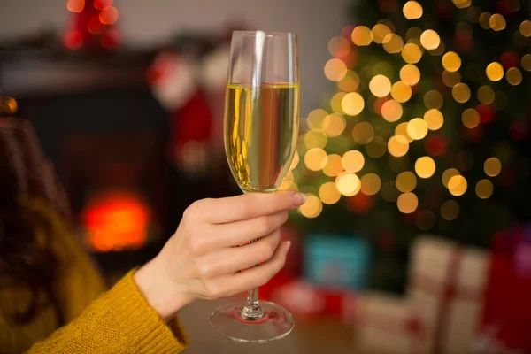 Rousse tenant une coupe de champagne sur le canapé à Noël — Photo