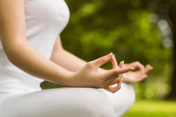 Woman sitting in lotus pose at park — Stock Photo, Image