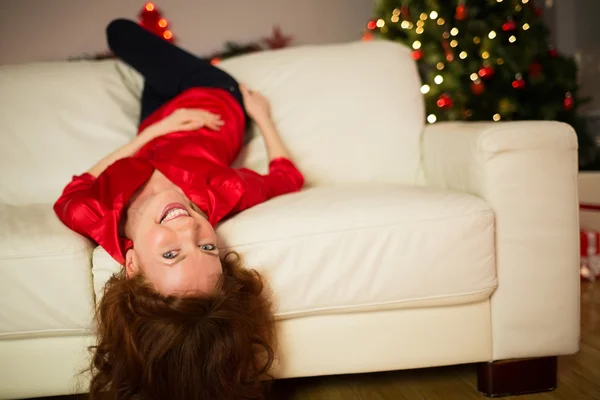 躺在沙发上，在圣诞节的快乐红发女郎 — 图库照片