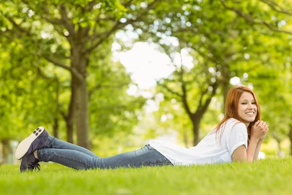 Pretty redhead cheerful and lying — Stock Photo, Image