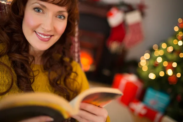 Peaceful redhead reading a book at christmas — Stock Photo, Image