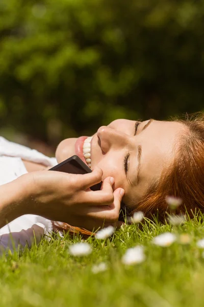 Pretty redhead calling and lying — Stock Photo, Image