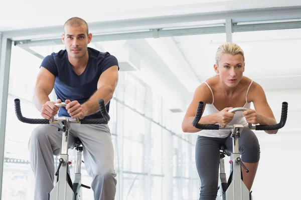 Pareja trabajando en bicicletas estáticas —  Fotos de Stock