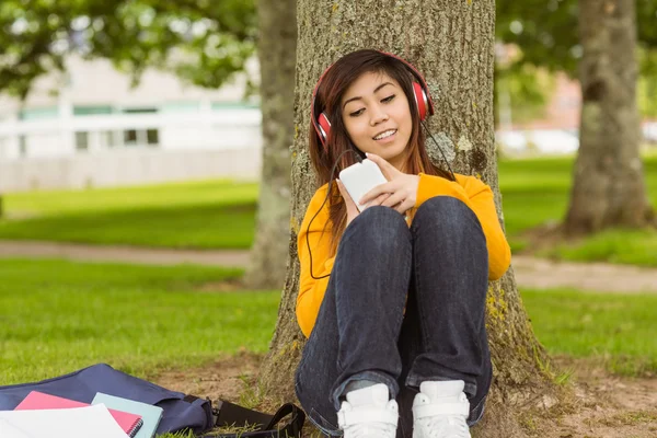 Женщина наслаждается музыкой в парке — стоковое фото