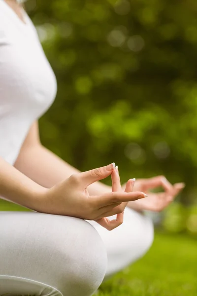 Woman sitting in lotus pose at park — Stock Photo, Image