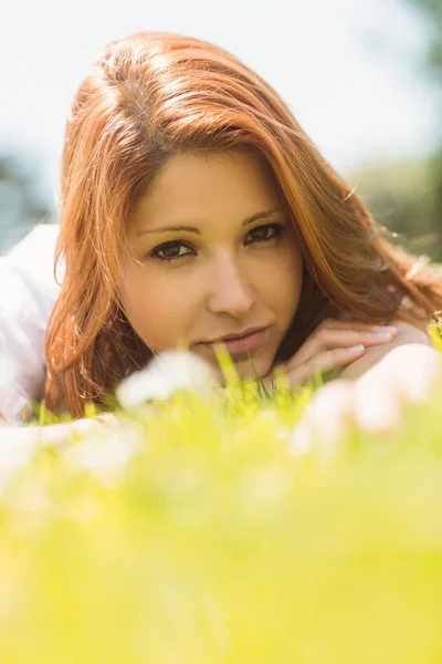 Portrait of a pretty redhead calm and lying — Stock Photo, Image