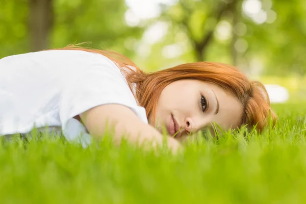 Portrait of a pretty redhead calm and lying — Stock Photo, Image