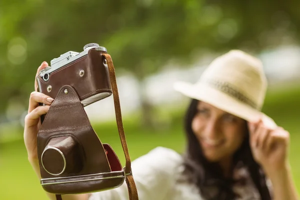 Smiling brunette taking a selfie with retro camera — Stock Photo, Image