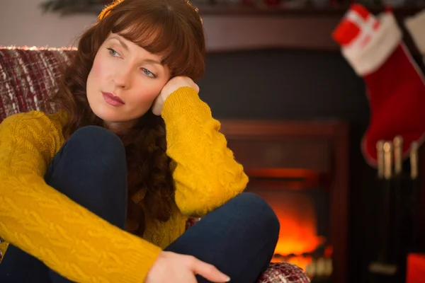 Pretty redhead in day dreaming at christmas — Stock Photo, Image
