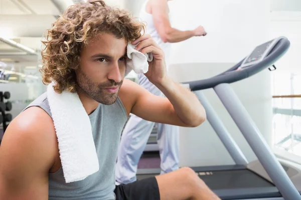 Handsome tired young man in gym — Stock Photo, Image