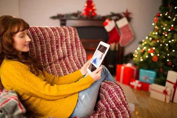 Rödhårig kvinna sitter på soffan använder tablet — Stockfoto