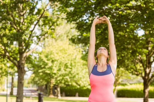 Fit brown hair stretching her arms — Stock Photo, Image