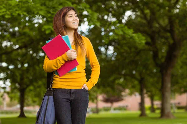 Female college student with books in park — Stock Photo, Image