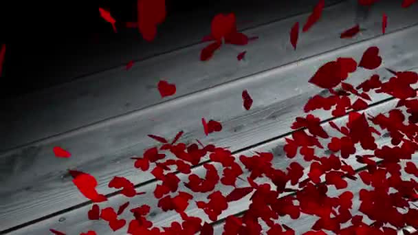 Red hearts falling on wooden surface — Stock Video