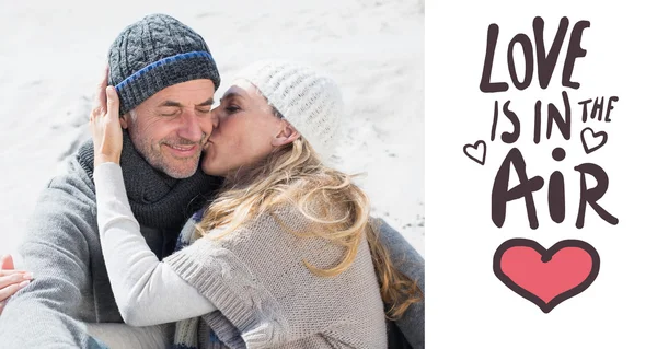 Attractive couple on the beach in warm clothing — Stock Photo, Image