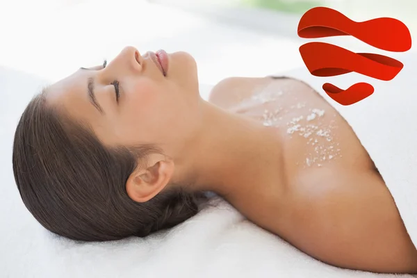 Beautiful brunette lying on massage table — Stock Photo, Image