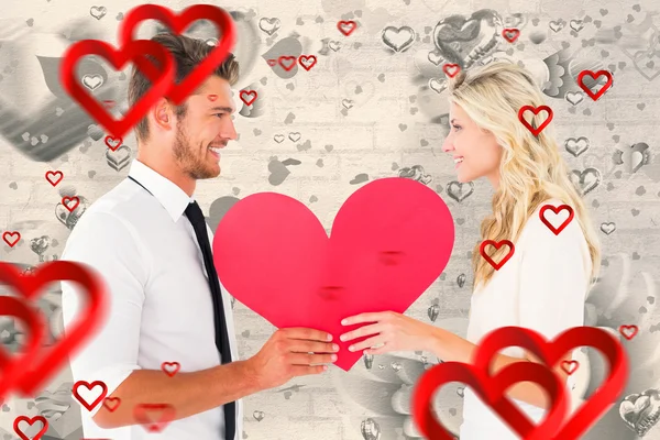 Attractive couple holding red heart — Stock Photo, Image