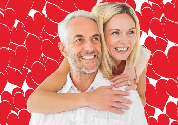 Man giving his partner a piggy back — Stock Photo, Image