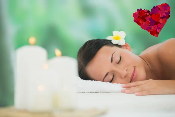 Beautiful brunette relaxing on massage table — Stock Photo, Image