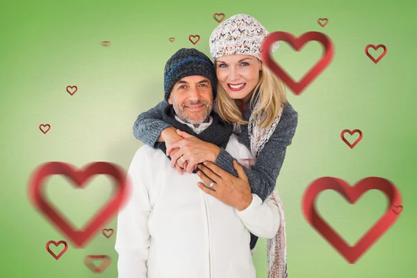 Happy couple in winter fashion embracing — Stock Photo, Image