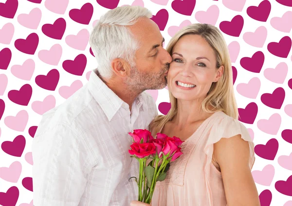 Affectionate man kissing wife on cheek — Stock Photo, Image