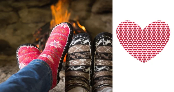 Legs in socks in front of fireplace — Stock Photo, Image