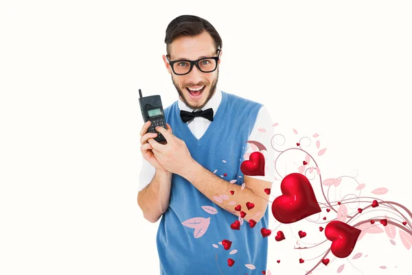 Geeky hipster holding retro cellphone — Stock Photo, Image