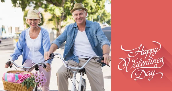 Happy mature couple going for a bike ride — Stock Photo, Image