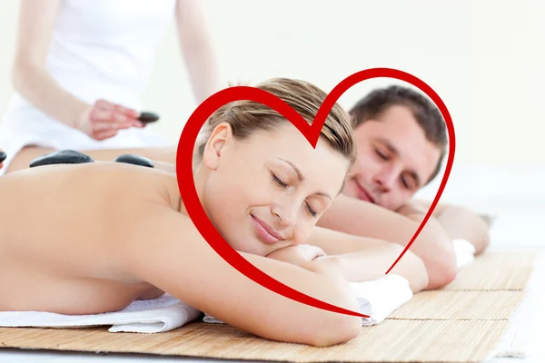 Young couple having a massage with hot stone — Stock Photo, Image