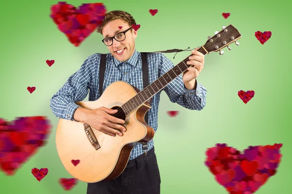 Geeky hipster playing the guitar — Stock Photo, Image