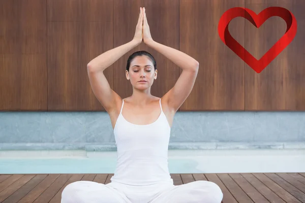 Peaceful woman in white sitting in lotus pose — Stock Photo, Image